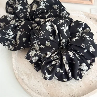 Elegant black floral cloth headband for women, perfect for high ponytails, stylish and hair-friendly.