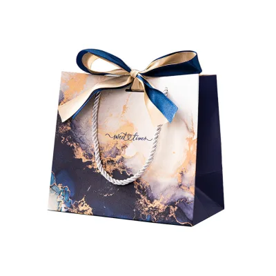 Eco-friendly White Cardboard Shopping Paper Bags with Ribbon Customizable Logo Cotton Handle Embossed Surface for Gift Packaging