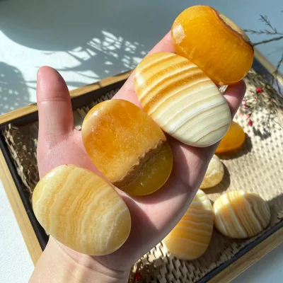 Wholesale Natural Yellow Calcite Crystal Palm Stones Hand Carved Tumbled Beauty Healing Stones for Home Decoration Polished