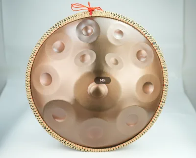 Customized wholesale 22-inch handpan drum with handbell. 14 tones on the Top-12 tones on the bottom, and 2 tones on the Bottom