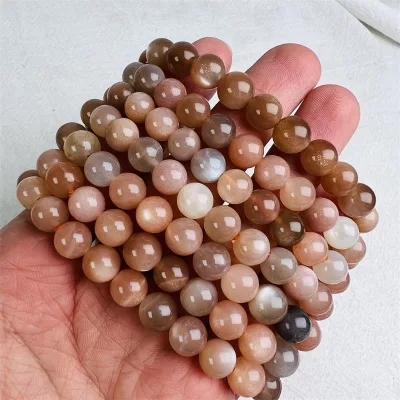 Wholesale natural high quality orange moonstone crystal bead carvings polished pink crystal round bracelet for gifts decoration