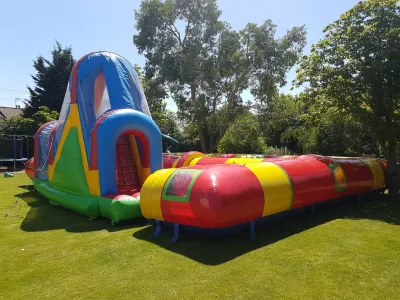 40 x 40 Giant Inflatable Maze includes: collision course, zigzag challenge, climbing area, slide, and ball pit finish line
