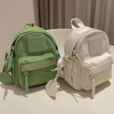 Japanese Style Compact Women's Backpack Macaron Color Oxford Material Custom Logo Fashionable Water Resistant Soft Zipper 20L