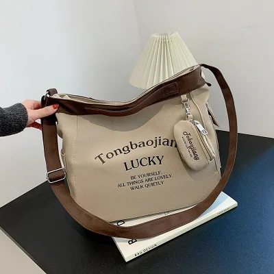 Korean version new large capacity student shoulder bag female pendant canvas bag Japanese versatile crossbody bag