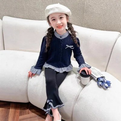 Trendy autumn outfit for a little girl featuring a long-sleeved top and flared pants.