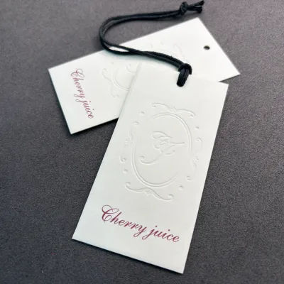 Custom Luxury Embossed Clothing Hang Tags Premium Paper Swing Labels for Garment Suits Evening Dresses and Designer Handbags